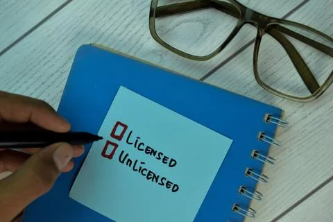 Licensed and Unlicensed write on sticky notes Stock Photos