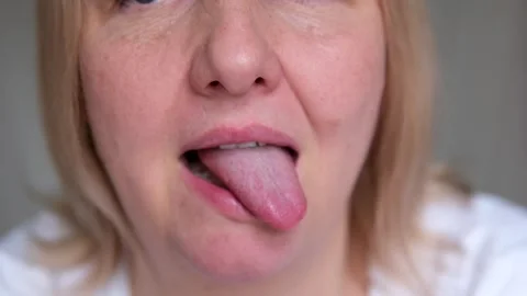 Lick lips Beautiful chubby lips. Woman's tongue seductively licking lips. Stock-Footage 287441473