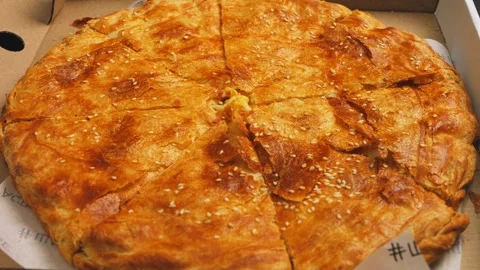 The lid of a cardboard box opens in which a fragrant miracle with a crust is Stock Footage 274453206