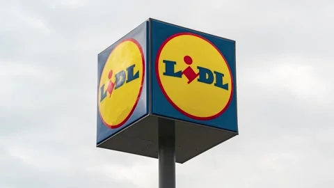 Lidl store sign. Clouds passing by. Clos... | Stock Video | Pond5