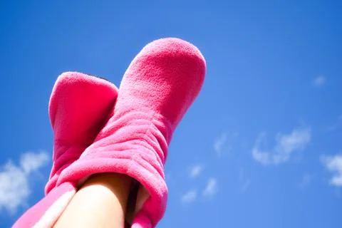 Lie down to the top. Clear blue sky and female legs in socks. Stock Illustration