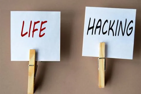 LIFE and HACKING - words on white sheets of paper with clothespins on a cof.. Stock Photos