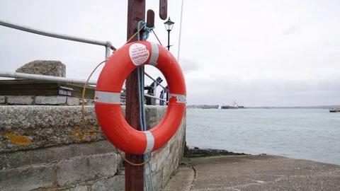 Life buoy at the Portsmouth harbour, England - pan Stock Footage