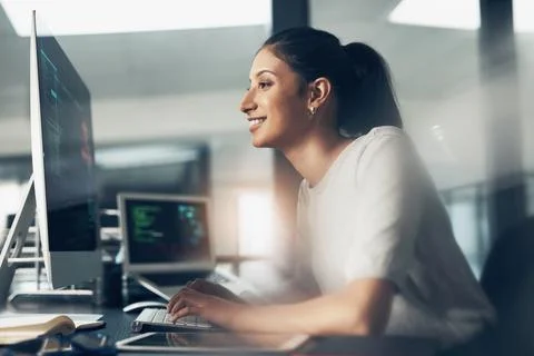 Life as a coder. Shot of a woman using a computer in a modern office. 스톡 사진