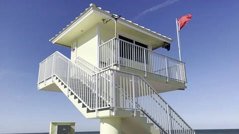 Life guard tower red flag along coast Stock Footage 236508842