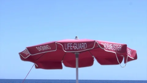 Life guards' parasol moving in the wind (4k) Video stock 79037745