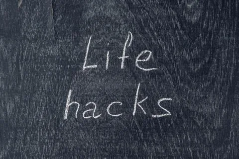 Life hacks written on the blackboard using chalk Stock Photos