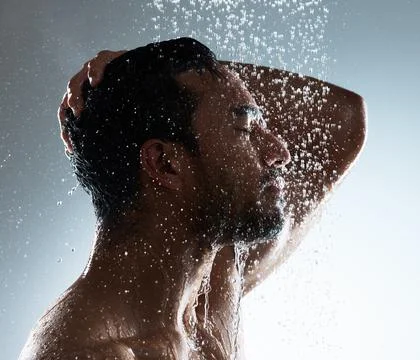 Life is incoherent, accept its flow. Studio shot of a young man washing his hair Stock Photos
