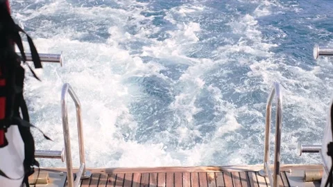 Life jacket on ladders on the rear deck of a yacht moving at sea 스톡 동영상 235918403