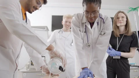 Life lessons: doctors demonstrate first aid techniques on a mannequin Stock Footage 275360940