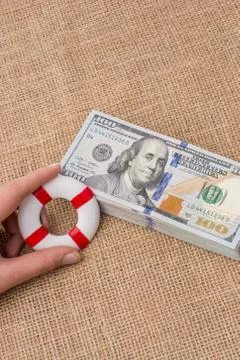Life preserver on the banknote bundle of US dollar Stock Photos