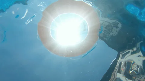 Life preserver floating in a clear pool water, slow motion, underwater view Stock Footage 140941787