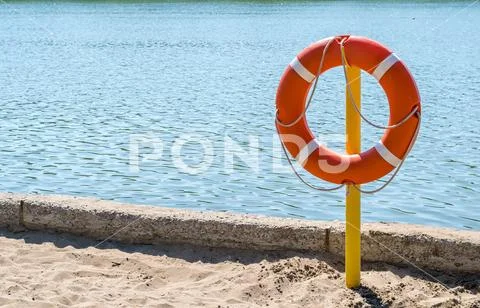 A life preserver on the shore of the lake to rescue drowning Stock Photos