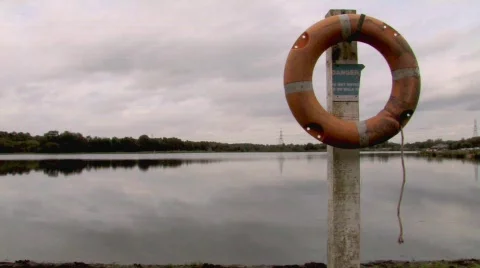 Life Ring At Waters Edge And Danger Sign Stock Footage 261452
