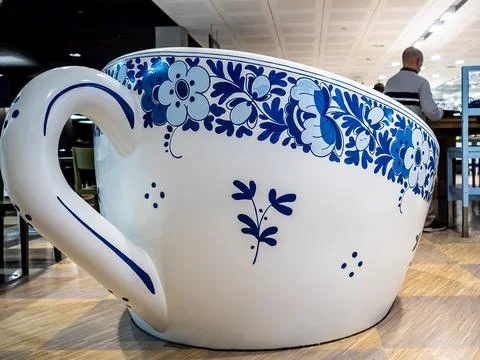 Life-size ceramic Tea Cup showcased in Traditional Delft Blue Pottery Design Stock Photos