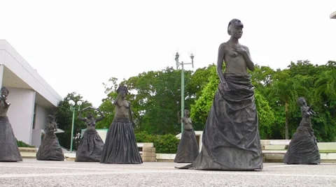 Life size Statues of Caribbean Topless Women at performing arts theater premises Stock Footage 7736219