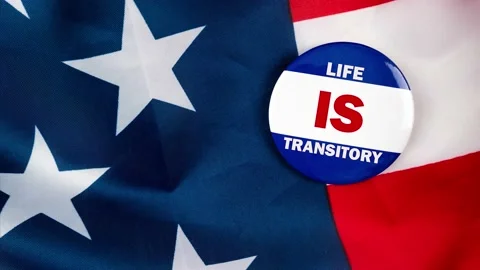 Life is transitory text quote on election button laying on the star spangled  Video stock 170629636