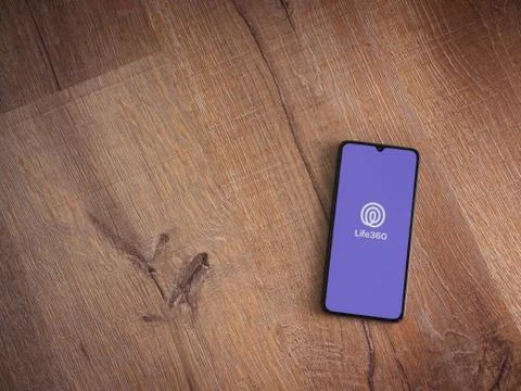 Life360 app launch screen with logo on the display of a black mobile smartpho Stock Photos