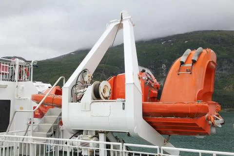 Lifeboat attached to a ferry in Norway. Stock Photos