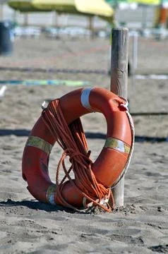 Lifebuoy and rope on the beach Stock Photos