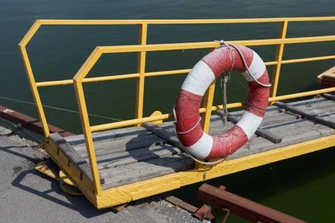 Lifebuoy hangs on the railing of the transitional bridge Stock Photos