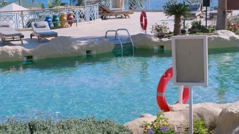 Lifebuoy at the pool. In the foreground is a pool, behind you can see the sea an Stock Footage 240200757