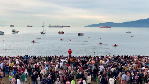 Lifeguard And Anonymous Crowd Viewing Polar Bear Swim Race At English Bay Beach Stock Footage 260270873