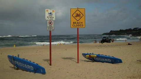 Lifeguard boards next to beach closed sign in Sydney Australia 6K Video stock 305516480