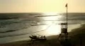 Lifeguard boat and observation tower on coast at sunset HD Footage