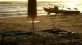 Lifeguard boat, umbrella and sunbed on the beach at sunset HD Footage