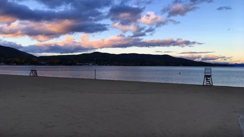 Lifeguard Chairs on Empty Lake Beach at Sunset Stock Footage 98415983