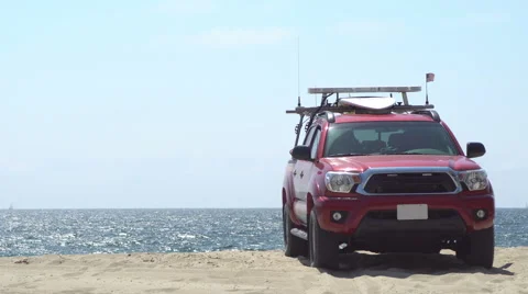 Lifeguard jeep on sand by the ocean Stock Footage 66202953