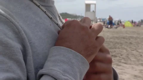 Lifeguard Putting Whistle on Chest While Standing on Beach - Close Up   Vidéo 169260369