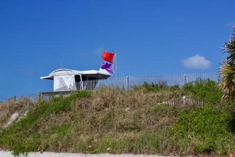 Lifeguard stand with warning flags. Stock Photos