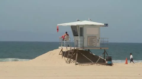 Lifeguard Tower and lifeguard on Huntington Beach Stock Footage