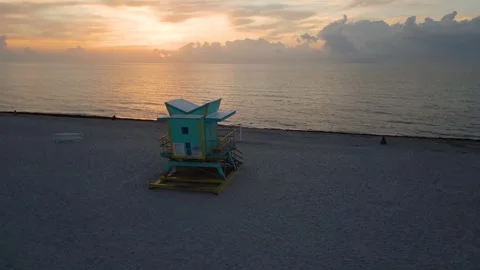 Lifeguard tower glowing under a miami sunrise Stock Footage 346262675
