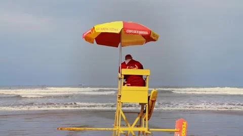Lifeguard using your cell phone while at work. Distracted lifeguard. Stock Footage 241975184