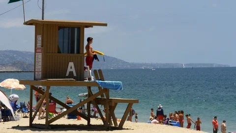 Lifeguard watches people swimming near Balboa Pier on Newport Beach, CA. Stock Footage