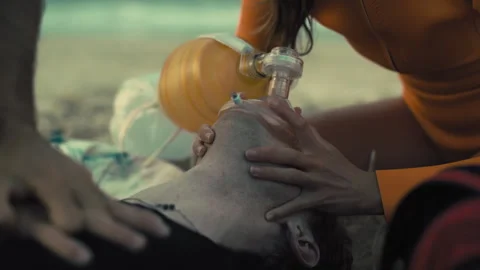 Lifeguards Performing a Cpr on the Beach Stock Footage 263910930