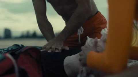 Lifeguards Performing Cpr at the beach professionally Stock Footage 263915516