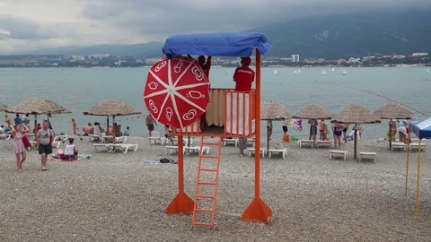 Lifeguards  on a tower on the beach Stock Footage 79282295