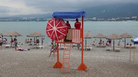 Lifeguards  on a tower on the beach Stock Footage 79282413