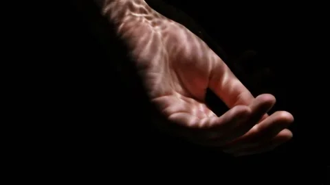 Lifeless hand floating under water on a black background. Stock Footage 200990099