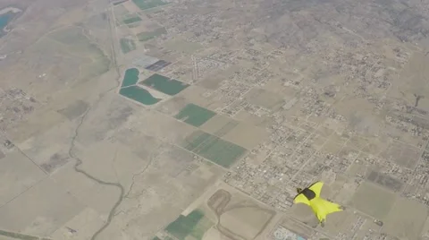 Lifestream men jumping with a wingsuit parachute, slow motion Stock Footage 66538341