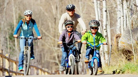 Lifestyle leisure Caucasian family parents children bicycle vacation outdoor Stock Footage