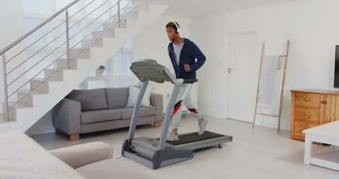 Lifestyle videos indoor of people doing activities at home, running on treadmill Stock Footage 345570341