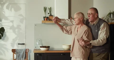 LIFETIME DEVOTION Happy beautiful 60s senior romantic couple have fun dancing Vídeos de archivo 162481656