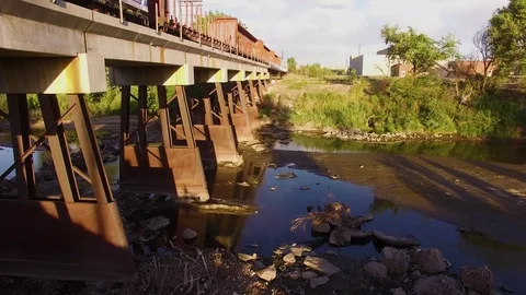 Lift up over river and train Color Corrected Stock Footage 98845331