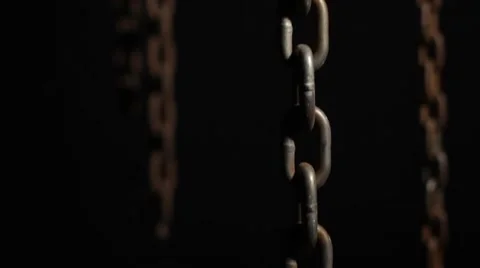 A lift shot of hanging rusty old chains Stock Footage