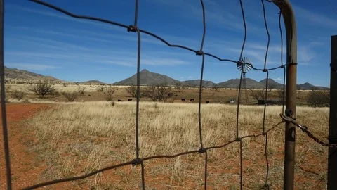 Lift shot of a ranch windmill and cattle tank Stock Footage 73968254